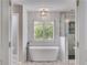Bathroom featuring a soaking tub, walk-in shower, and tiled floor at 5473 Heatherbrooke Nw Dr, Acworth, GA 30101