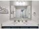 Bright bathroom with dual sinks, quartz countertops, and ample storage at 5473 Heatherbrooke Nw Dr, Acworth, GA 30101