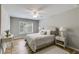 Cozy bedroom with natural light, ceiling fan, neutral colors, and wood flooring at 5473 Heatherbrooke Nw Dr, Acworth, GA 30101