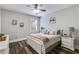 Bedroom with a queen-sized bed, white nightstands, warm, neutral bedding, and natural light for a restful retreat at 5473 Heatherbrooke Nw Dr, Acworth, GA 30101