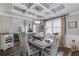 Elegant dining room features decorative ceiling and modern lighting over wood dining table at 5473 Heatherbrooke Nw Dr, Acworth, GA 30101