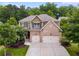 Charming two-story home boasts a brick and tan exterior, lush landscaping, and a two-car garage at 5473 Heatherbrooke Nw Dr, Acworth, GA 30101