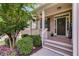 Inviting front porch with brick accents, tasteful decor, and lush, manicured landscaping at 5473 Heatherbrooke Nw Dr, Acworth, GA 30101