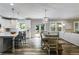 Open-concept kitchen featuring a large island, modern lighting, and stainless steel appliances at 5473 Heatherbrooke Nw Dr, Acworth, GA 30101