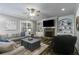 Cozy living room features a stone fireplace, built-in shelving, a ceiling fan and a large window for natural light at 5473 Heatherbrooke Nw Dr, Acworth, GA 30101