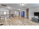 Open living area with wood floors, staircase with rod iron, lots of light, and neutral walls at 5473 Heatherbrooke Nw Dr, Acworth, GA 30101