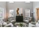 Well-lit living room featuring a soaring ceiling, stylish decor, and comfortable seating at 5473 Heatherbrooke Nw Dr, Acworth, GA 30101