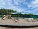 Community playground with climbing dome, swings, slides, and covered picnic area at 5473 Heatherbrooke Nw Dr, Acworth, GA 30101