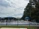 Community splash pad with sprinklers and shaded seating areas, perfect for summer fun at 5473 Heatherbrooke Nw Dr, Acworth, GA 30101