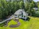 Beautiful home with stunning curb appeal, complemented by lush landscaping and a winding driveway at 6070 Lively Ct, Cumming, GA 30040