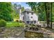 Spacious backyard with stone patio, fire pit, lawn, and three-car garage at 6070 Lively Ct, Cumming, GA 30040