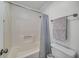 Cozy bathroom featuring tub and shower, and light grey towels and shower curtain at 6070 Lively Ct, Cumming, GA 30040