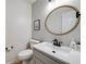 Charming powder room with decorative mirror, gray walls and modern fixtures at 6070 Lively Ct, Cumming, GA 30040