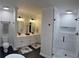 Elegant bathroom featuring double vanities, and a walk-in shower with white subway tile at 6070 Lively Ct, Cumming, GA 30040