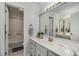 Neutral bathroom featuring white vanity, marble countertop, and combination shower at 6070 Lively Ct, Cumming, GA 30040
