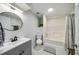 Modern bathroom featuring vanity sink and shower over tub with neutral accents at 6070 Lively Ct, Cumming, GA 30040