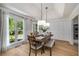 Bright dining room features hardwood floors, pendant lighting, and a large window overlooking the front yard at 6070 Lively Ct, Cumming, GA 30040