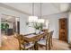 Dining room boasts wood floors, designer lighting, and flows into the kitchen, perfect for entertaining at 6070 Lively Ct, Cumming, GA 30040
