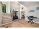 Inviting foyer featuring hardwood floors and an open staircase at 6070 Lively Ct, Cumming, GA 30040