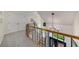 Bright hallway with staircase and wrought iron railing and chandelier at 6070 Lively Ct, Cumming, GA 30040