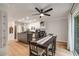 Eat-in kitchen features white cabinetry, island with granite countertops, and stainless steel appliances at 6070 Lively Ct, Cumming, GA 30040