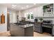 The kitchen offers gray lower cabinets, white upper cabinets, stainless steel appliances, and granite countertops at 6070 Lively Ct, Cumming, GA 30040