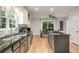 Bright kitchen with granite countertops, stainless steel appliances, and a view of the dining area at 6070 Lively Ct, Cumming, GA 30040