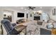 Open concept living room with a fireplace, hardwood floors, and gray sectional sofa at 6070 Lively Ct, Cumming, GA 30040
