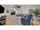Cozy living room with a fireplace, gray sectional sofa, and a ceiling fan at 6070 Lively Ct, Cumming, GA 30040