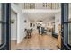 Bright open concept featuring hardwood floors, a fireplace, and a comfortable seating area at 6070 Lively Ct, Cumming, GA 30040