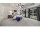 Spacious main bedroom featuring trey ceiling, ceiling fan, carpet, and large windows overlooking the front yard at 6070 Lively Ct, Cumming, GA 30040