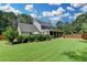 Gorgeous home featuring a large back yard, a charming screened-in porch, and lush landscaping, creating a private outdoor retreat at 939 Flowers Xing, Lawrenceville, GA 30044