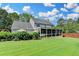Lovely home features a large back yard, a cozy screened-in porch, and well-maintained landscaping, ideal for relaxation and entertainment at 939 Flowers Xing, Lawrenceville, GA 30044