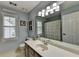 Bright bathroom with a large mirror, ample counter space, and stylish lighting fixtures at 939 Flowers Xing, Lawrenceville, GA 30044