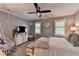 Cozy bedroom with a stylish ceiling fan, chandelier and a hanging swing chair at 939 Flowers Xing, Lawrenceville, GA 30044