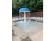 Community pool area featuring a mushroom fountain and ample lounge chairs, perfect for enjoying a refreshing swim on a sunny day at 939 Flowers Xing, Lawrenceville, GA 30044