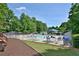 Community pool area featuring lounge chairs, umbrellas, and a well-maintained pool, offering a perfect spot for recreation and relaxation at 939 Flowers Xing, Lawrenceville, GA 30044