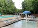 Inviting community pool area with wading pool, lounge chairs, umbrellas, and a picnic area, perfect for Gathering fun and relaxation at 939 Flowers Xing, Lawrenceville, GA 30044