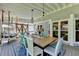 A bright dining area offers elegant lighting, with open access to a porch swing and the outdoors at 939 Flowers Xing, Lawrenceville, GA 30044