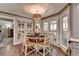 Bright dining area featuring hardwood floors, decor pieces, and a round table set for six at 939 Flowers Xing, Lawrenceville, GA 30044