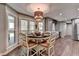 Bright dining area with a stylish light fixture and views of the backyard, adjacent to kitchen at 939 Flowers Xing, Lawrenceville, GA 30044