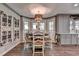 Inviting dining area featuring a round table, natural light, and wood flooring at 939 Flowers Xing, Lawrenceville, GA 30044
