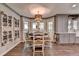 A dining area includes gray walls, hardwood floors, and is furnished with a round table and chairs at 939 Flowers Xing, Lawrenceville, GA 30044