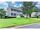 Traditional two-story home with a manicured lawn, complemented by dark shutters and an attached two car garage at 939 Flowers Xing, Lawrenceville, GA 30044