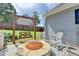 Outdoor fire pit provides a cozy spot, complete with a swing and rocking chairs, perfect for relaxation at 939 Flowers Xing, Lawrenceville, GA 30044