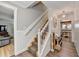 Elegant foyer features hardwood floors, staircase, and transitions into adjacent living spaces with stylish decor at 939 Flowers Xing, Lawrenceville, GA 30044