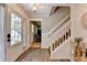 Warm foyer with hardwood floors, staircase, and stylish decor creates an inviting entrance to the home at 939 Flowers Xing, Lawrenceville, GA 30044