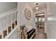 Light-filled foyer features hardwood floors, staircase, stylish accents, and seamless transition to dining area at 939 Flowers Xing, Lawrenceville, GA 30044