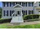 Inviting front entrance with white stairs, dark shutters, and neat landscaping, enhancing curb appeal at 939 Flowers Xing, Lawrenceville, GA 30044