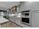 This home features a kitchen with gray cabinets and stainless steel appliances at 939 Flowers Xing, Lawrenceville, GA 30044